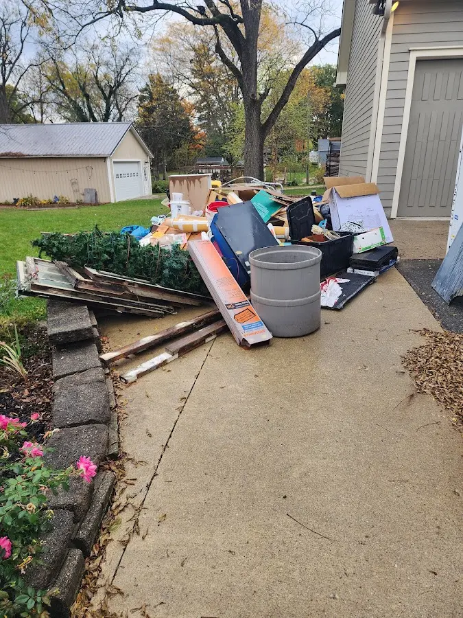Dumpster being loaded with debris for 12 Yard Dumpster Rental in Almena